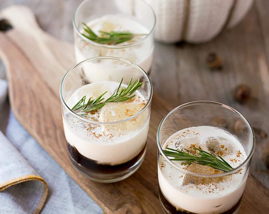 Spiced white russian cocktail recipe made with Raven's Nest mulling spice garnished with cinnamon and fresh rosemary