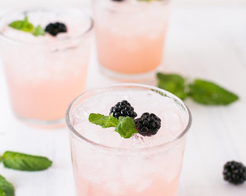 Spiked blackberry lemonade cocktail recipe made with cocktail simple syrup made from jam, Raven's Nest blackbery jalapeno jam, garnished with fresh blackberries and mint leaves